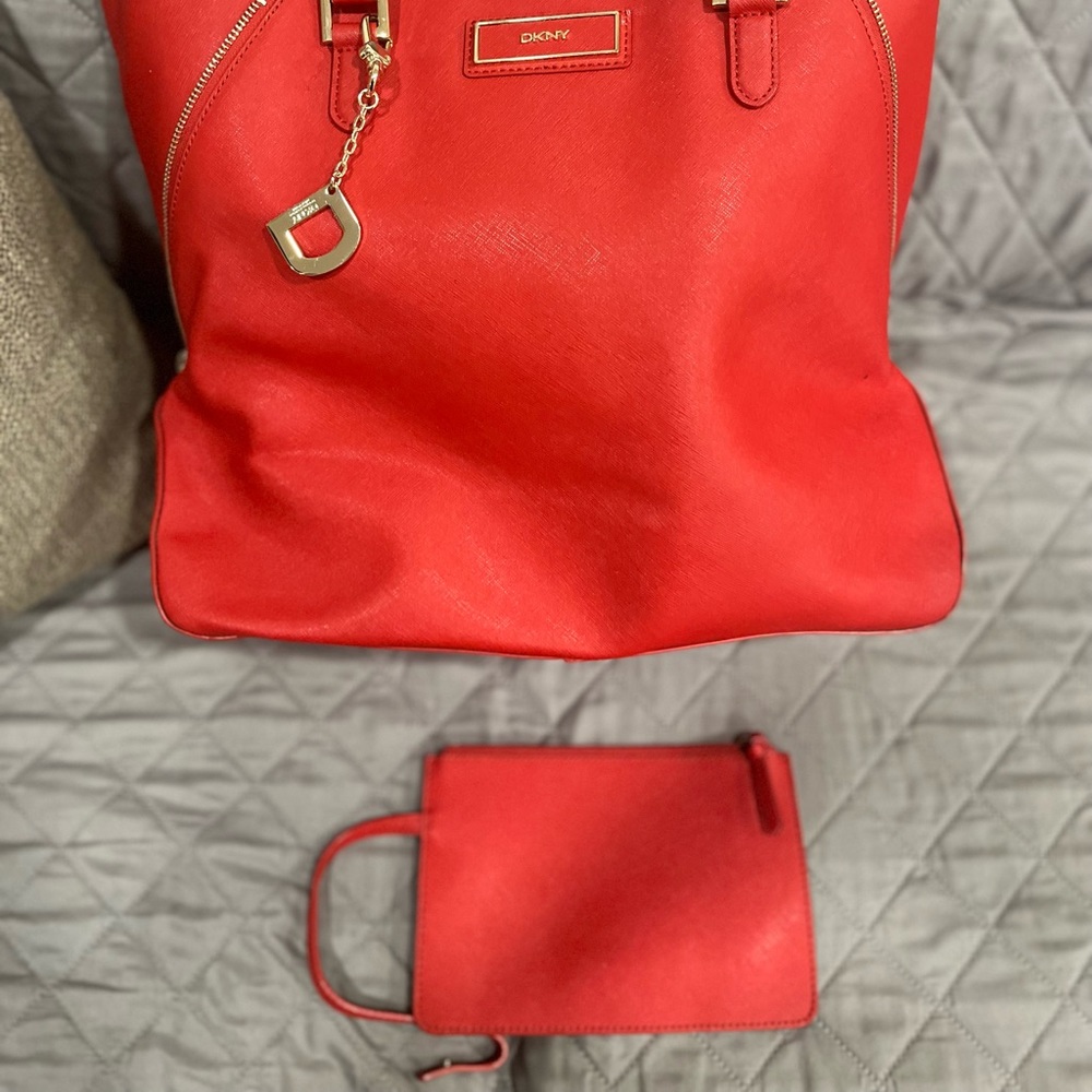 Red DKNY tote with small insert purse and dust bag.